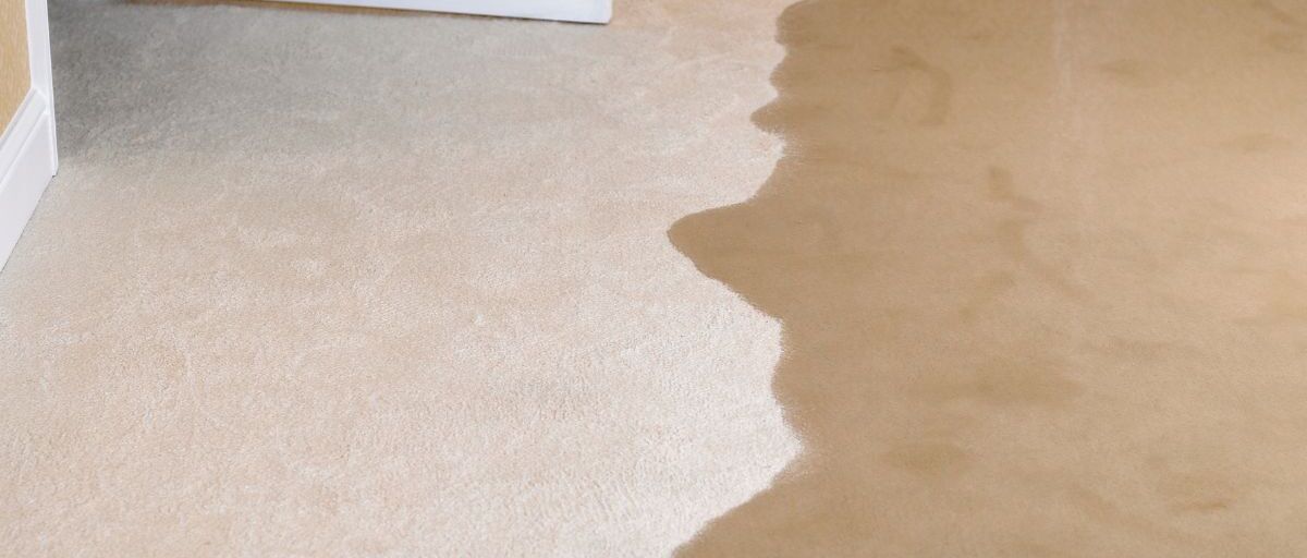 flooding water spreads quickly into a living room and causing water damage.